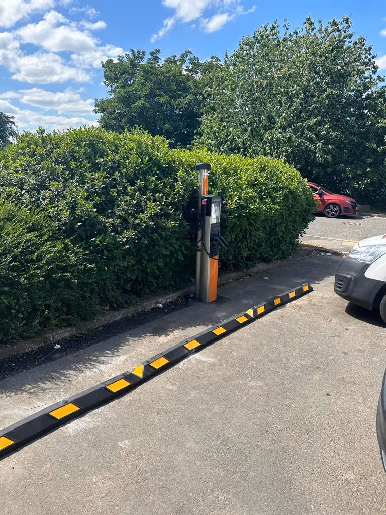 EV charging point installed at the edge of a car park
