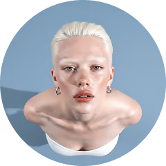 Person with pale skin and platinum blond hair looking up against a blue background.