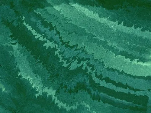 Abstract green textured pattern with wavy, zigzag lines. The overlapping shades of green create a dynamic, rippling effect, evoking movement.