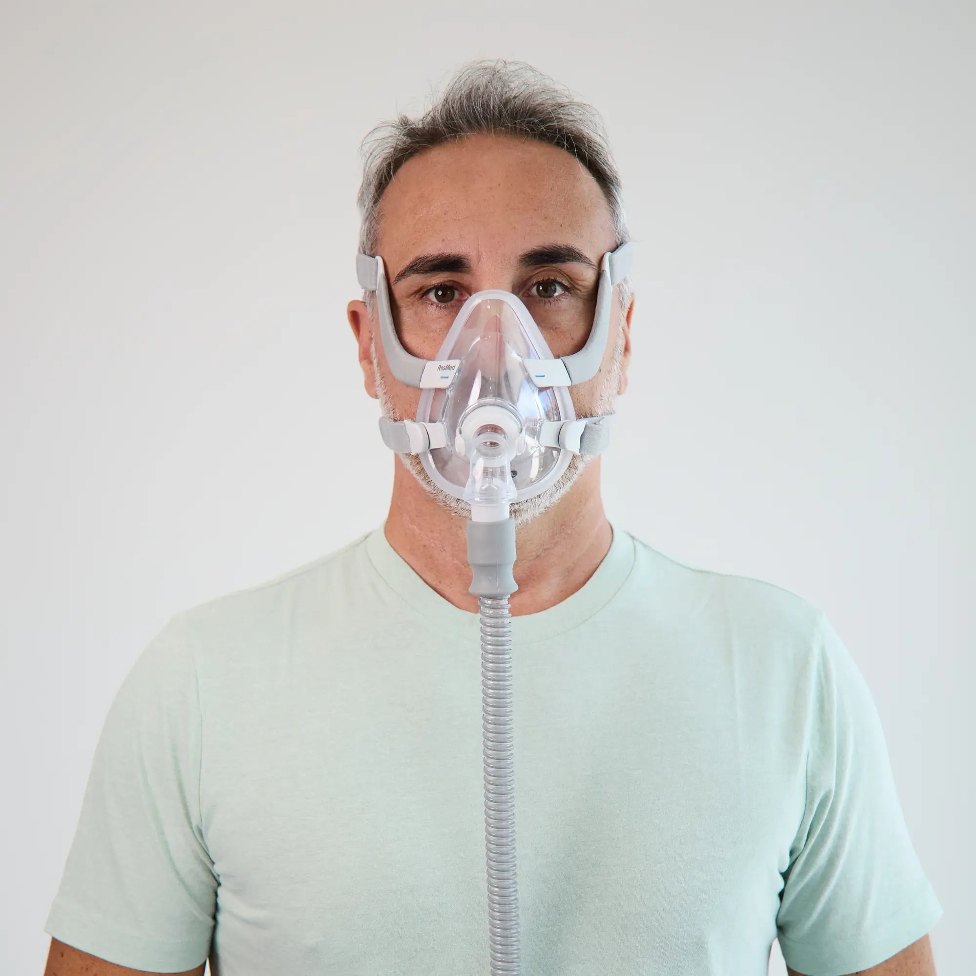 Man wearing the ResMed AirFit F20 full face mask