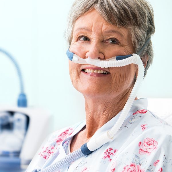 Smiling older woman wearing a nasal cannula for home oxygen therapy