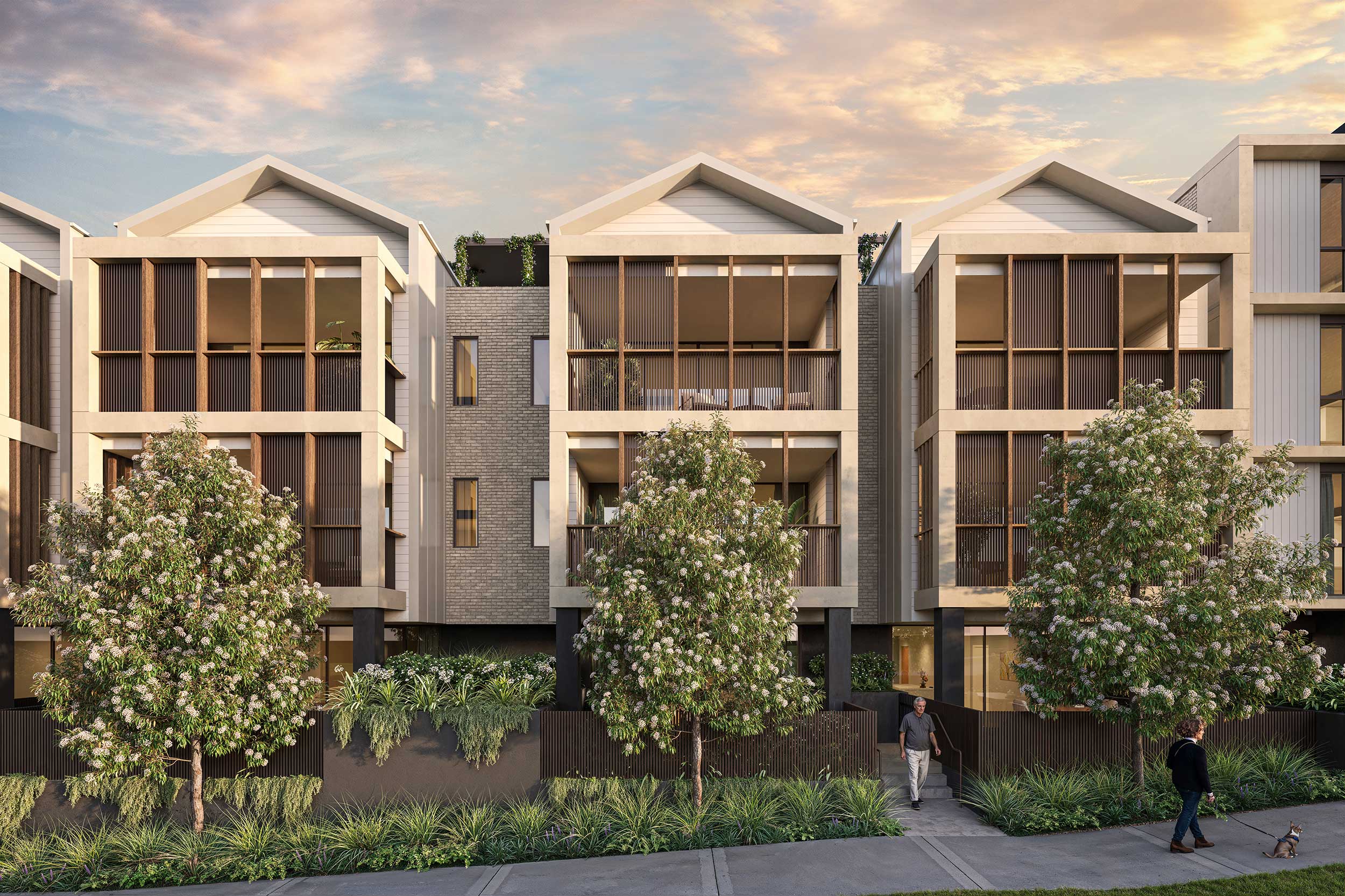 Modern townhouses with large wooden vertical slats on balconies and flowering trees in front.