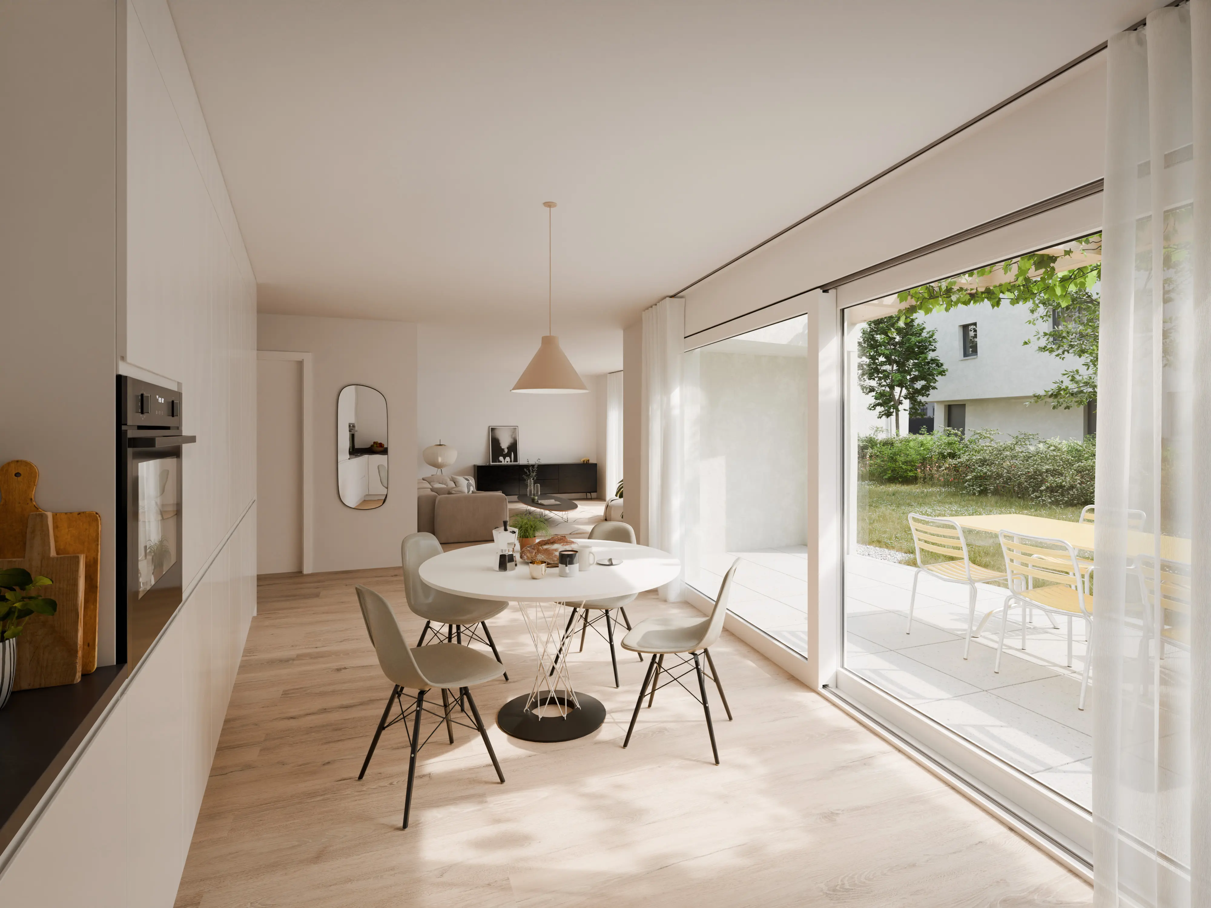 Cuisine moderne ouverte avec table ronde blanche, chaises, grandes baies vitrées donnant sur une terrasse et un jardin.