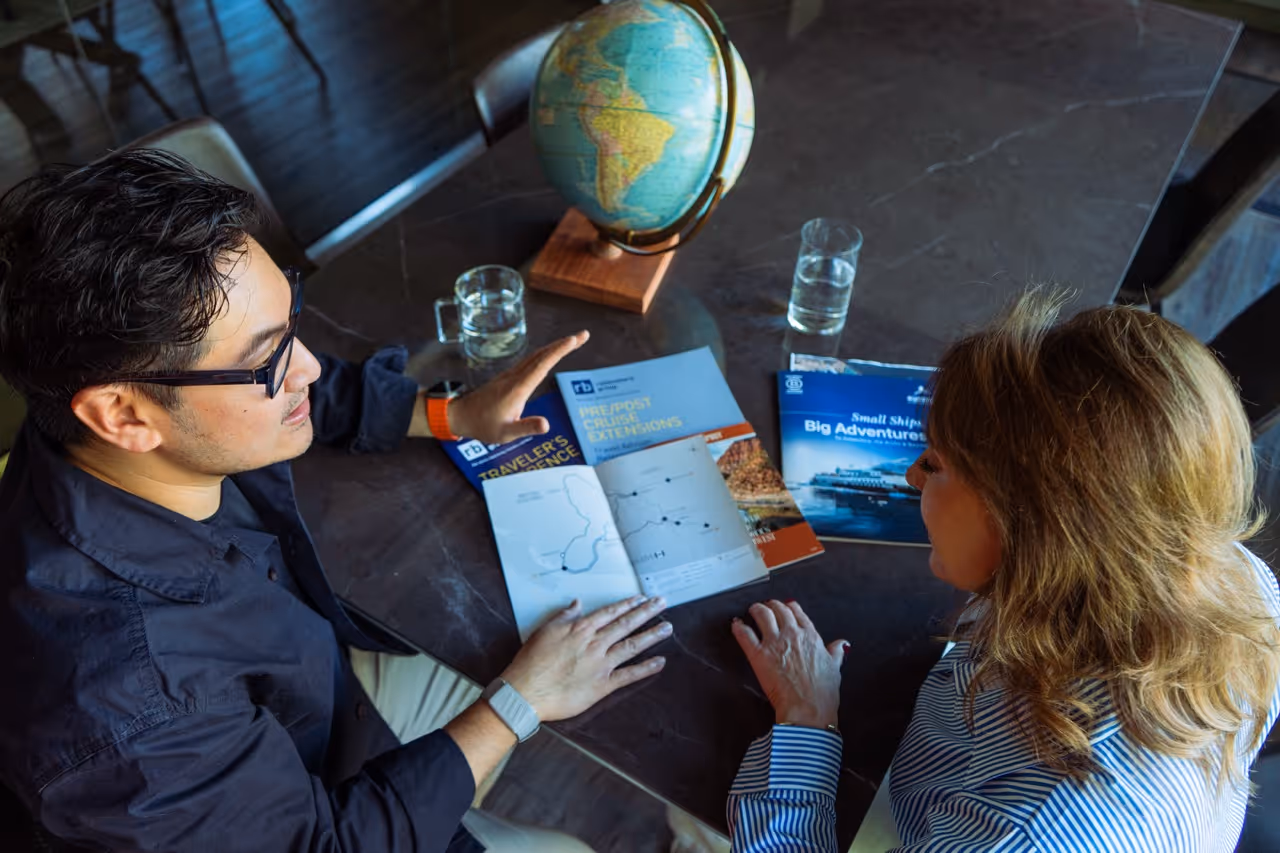 Travel designer reviewing a personalised itinerary with a client