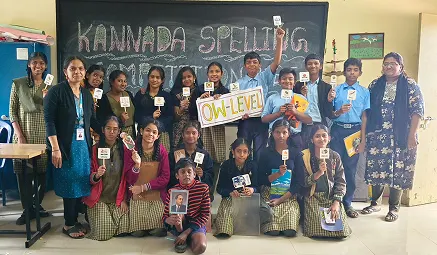 Students participating in a Kannada spelling competition at school