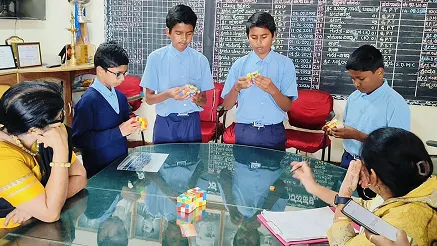 Students solving Rubik's Cubes during a problem-solving activity