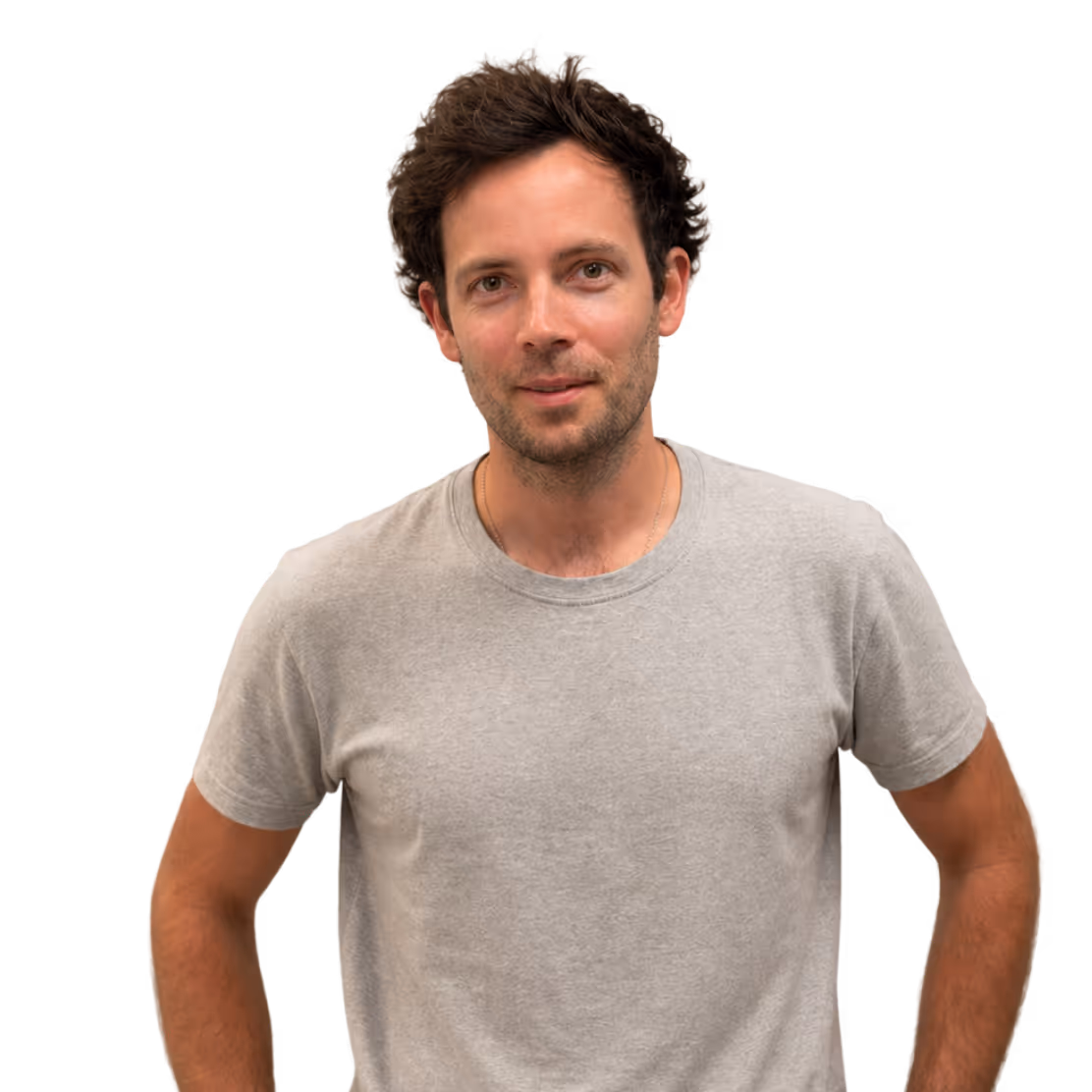 Man with dark hair wearing a light gray t-shirt against a transparent background.