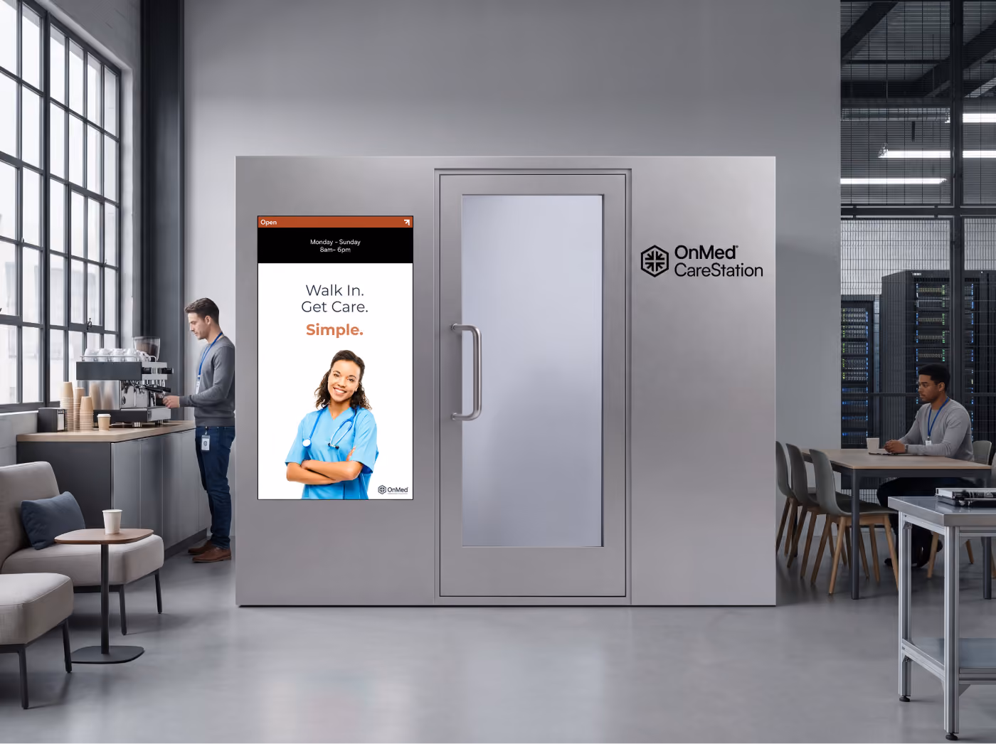 OnMed CareStation™ in gray in an office break room, with a video screen displaying "Walk In. Get Care. Simple." next to a data server room