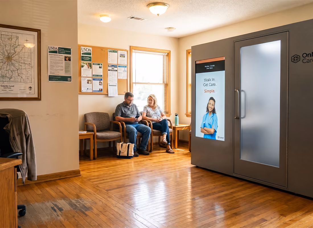 OnMed CareStation™ in an office waiting room with two people seated in chairs nearby