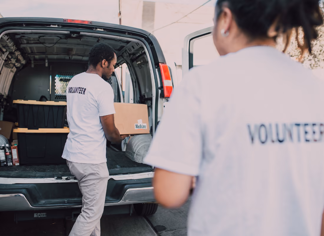 Healthcare workers loading medical supplies into a van, representing HRSA's Rural Health Care Services Outreach Program's mobile care delivery