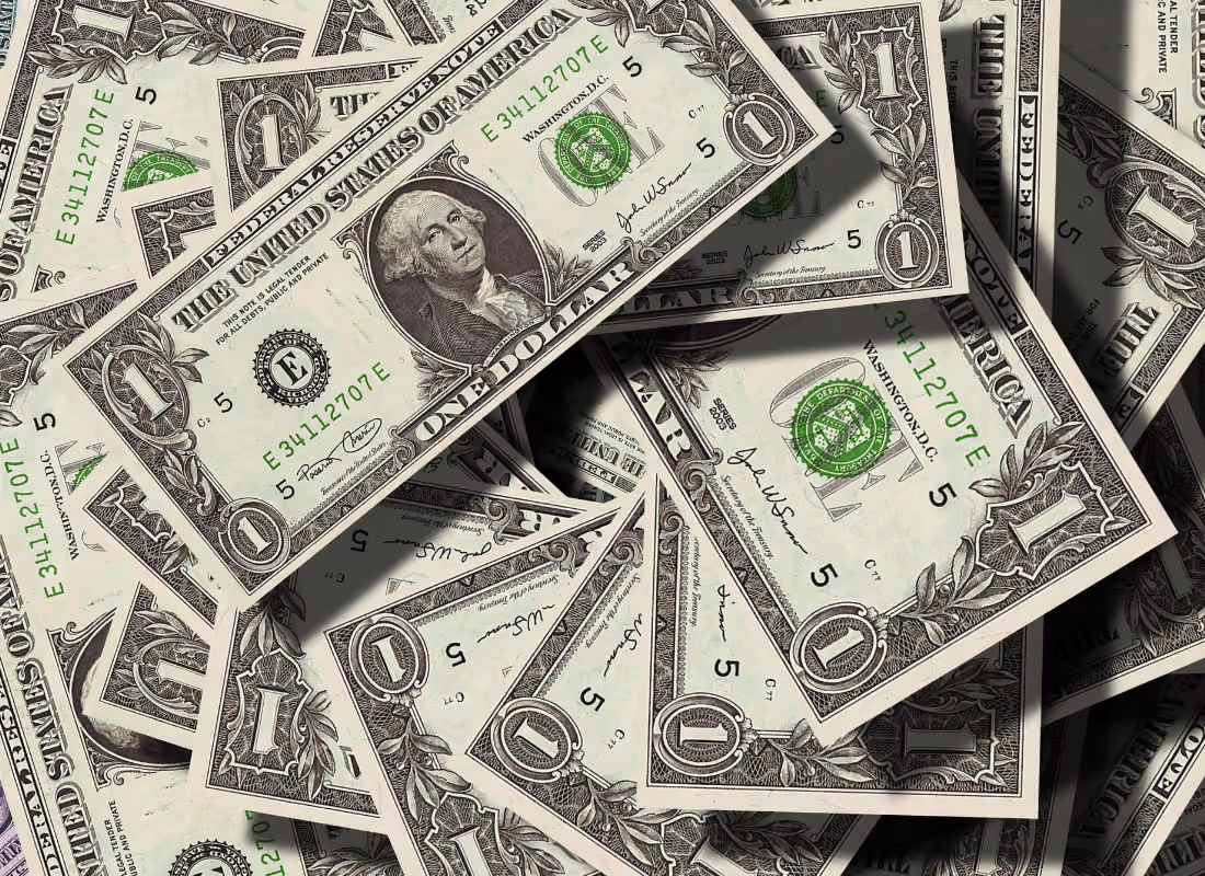 Close-up of scattered U.S. dollar bills, representing the $50 billion in state opioid settlement funds for treatment and recovery