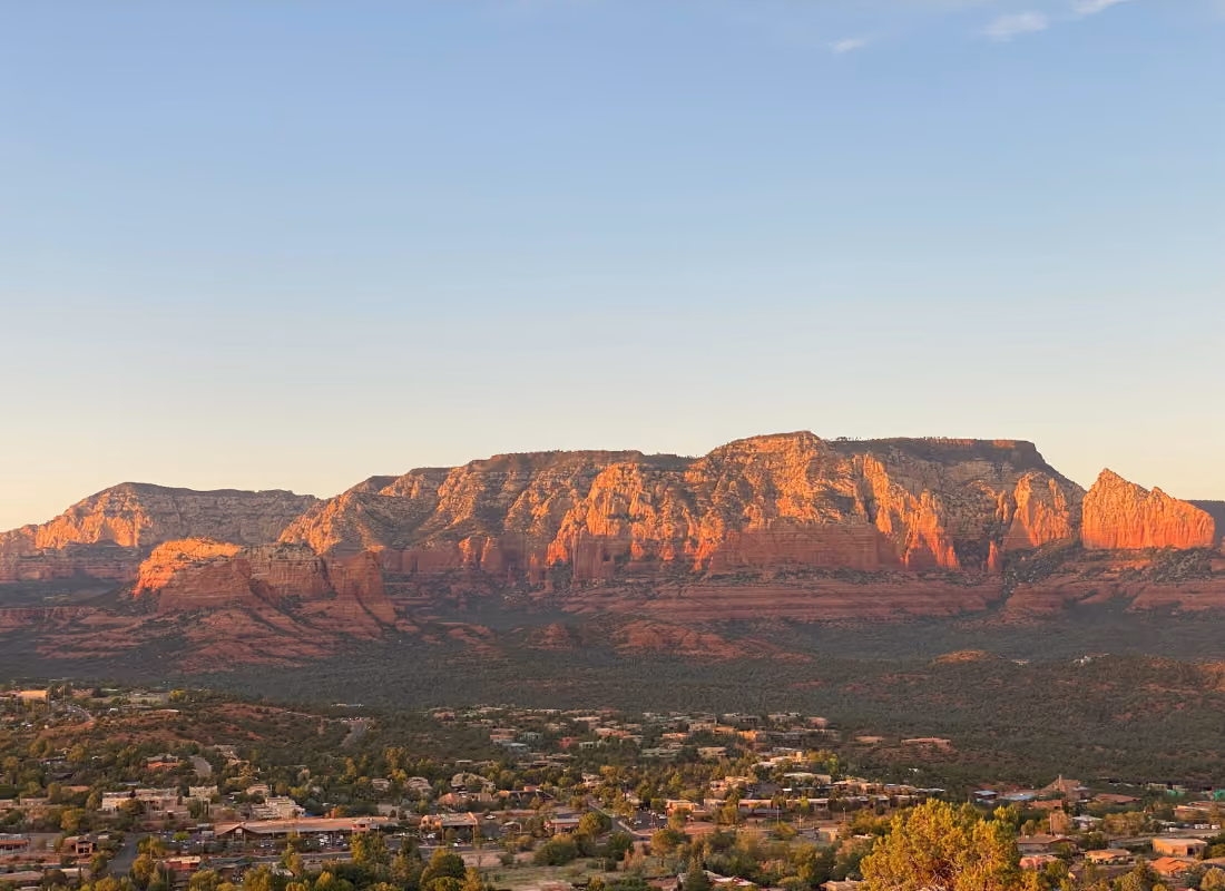 Aerial view of a small town against red rock desert formations at sunset, representing local governments spending remaining ARPA funds