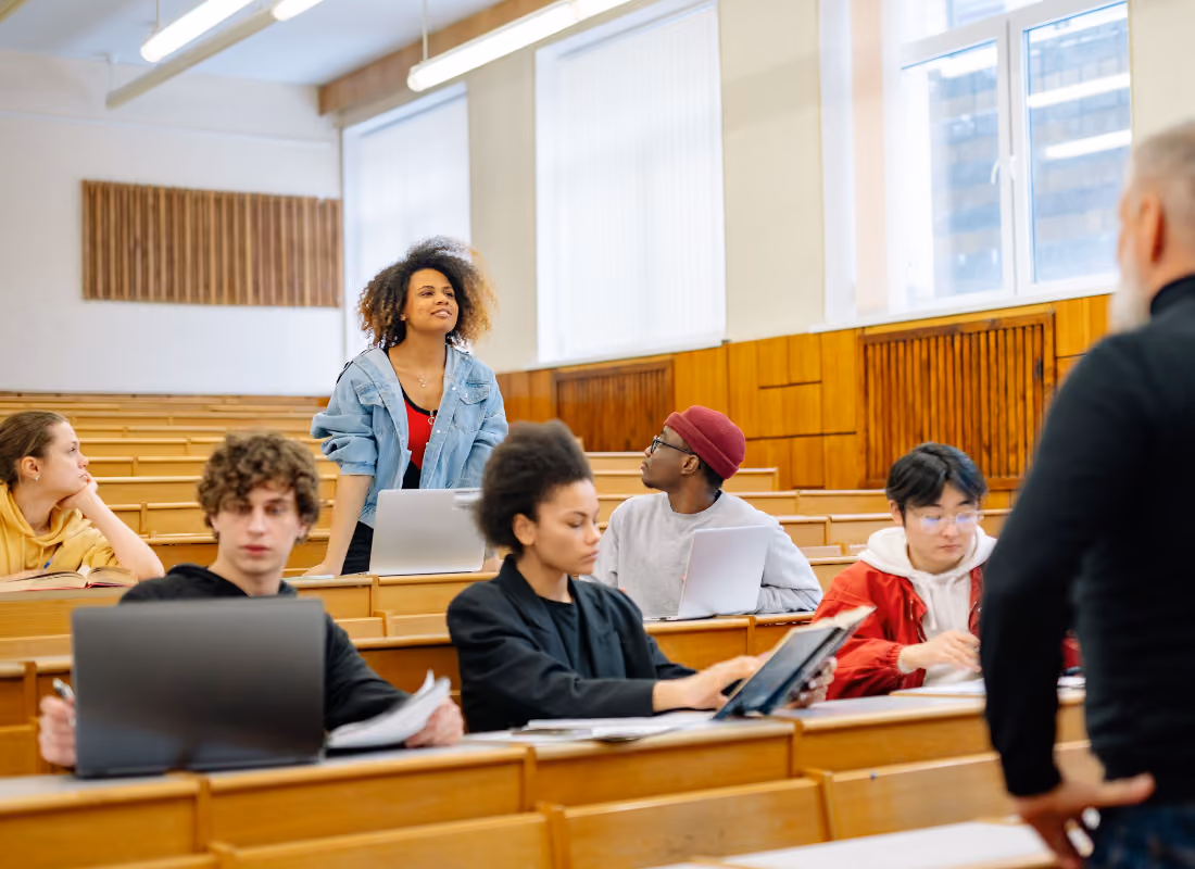 Professor addressing students in a college lecture hall, representing colleges funded by the Title III Strengthening Institutions Program