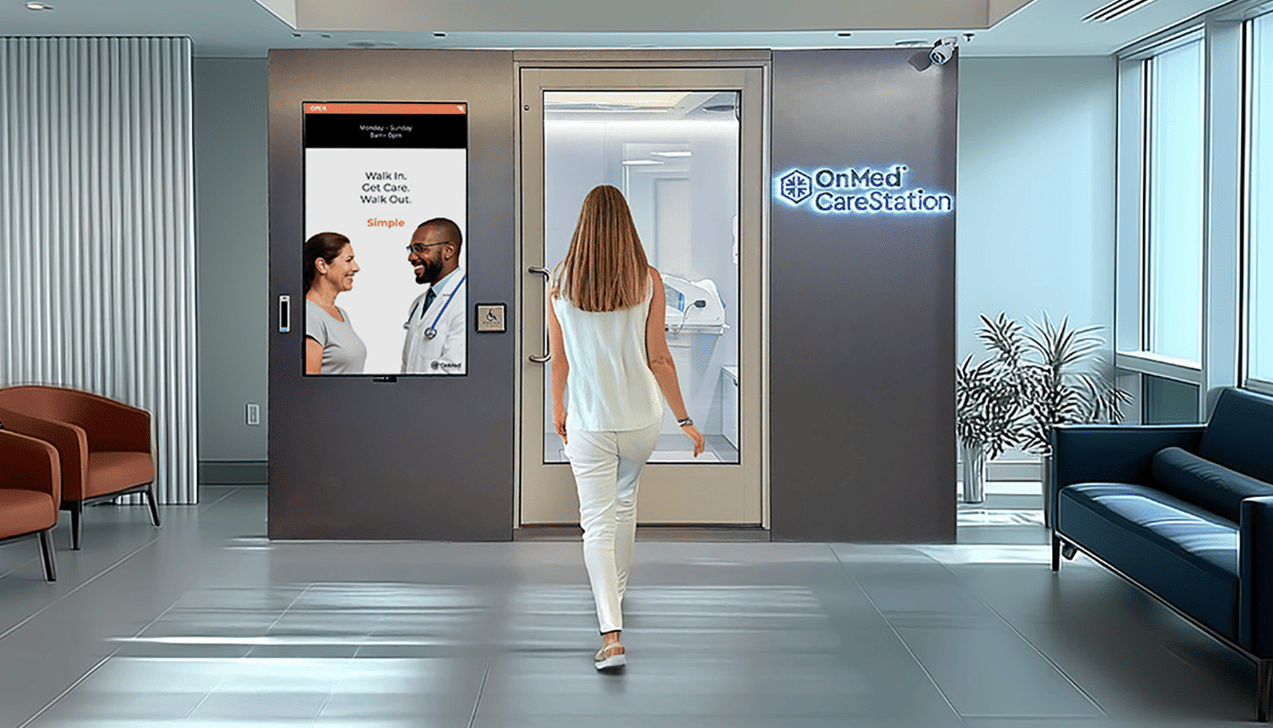 Woman walking toward an OnMed CareStation™ with its "Walk In. Get Care. Walk Out." screen and glowing logo in a modern lobby.