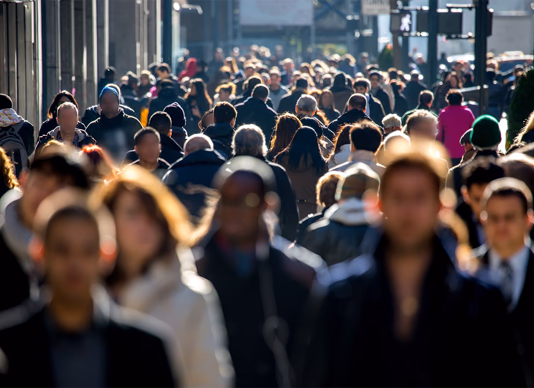 Crowd of people walking on a busy city sidewalk