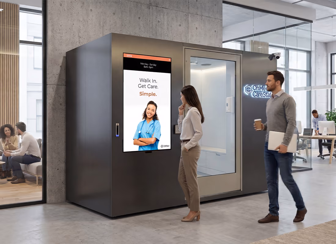 OnMed CareStation™ in gray in a modern office lobby with two people passing by