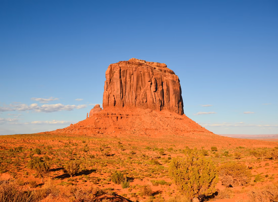 Butte rock formation in Monument Valley under a clear blue sky