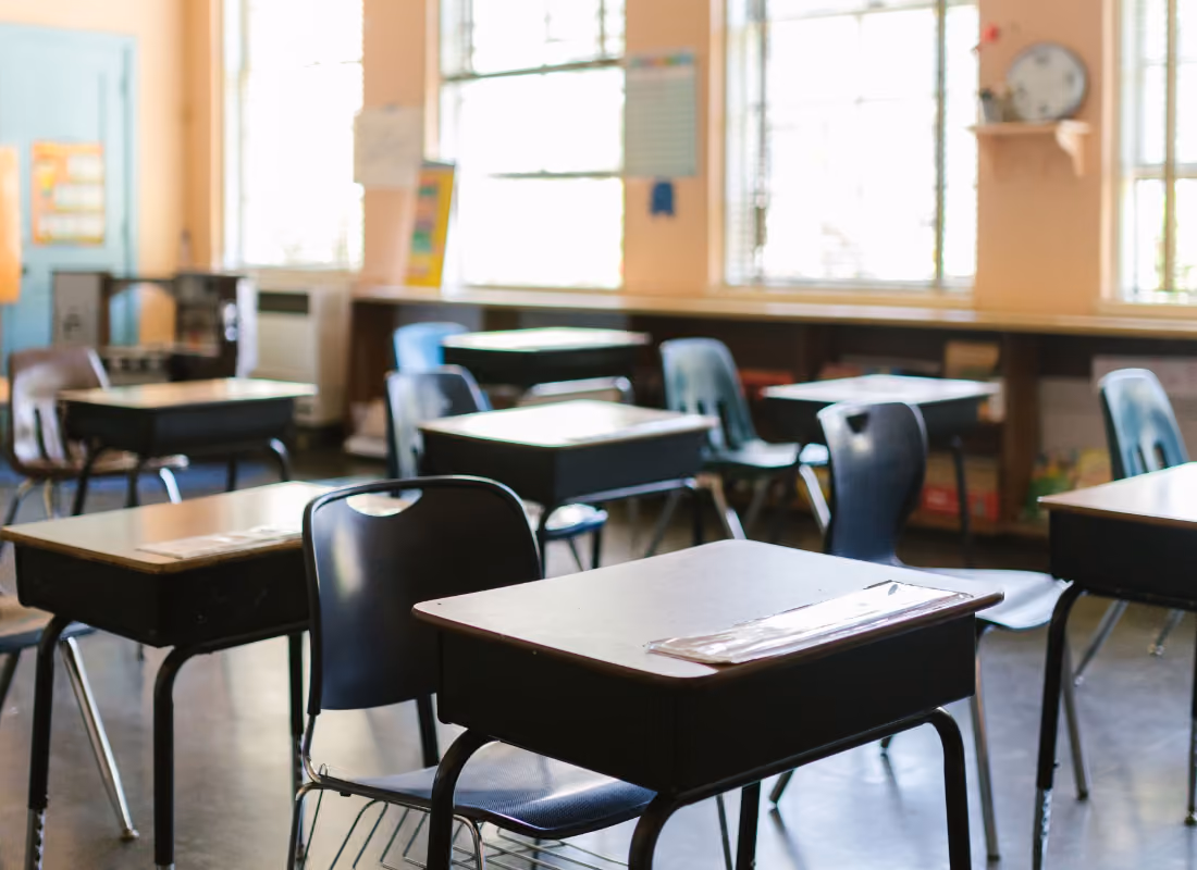 Empty classroom with desks and chairs arranged in rows