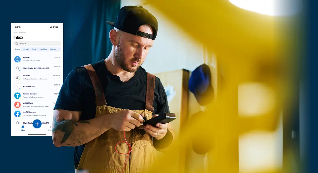 Man in overalls and cap using smartphone. A screenshot of the SignpostAI Mobile App is visible, indicating his Signpost Messaging Hub is available wherever his job takes him.