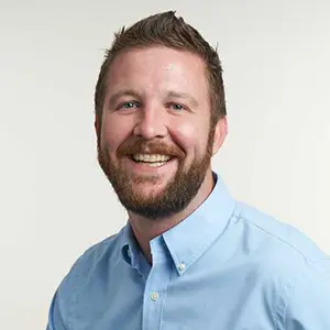A headshot of Dustin McCallister, VP of Revenue at SignpostAI