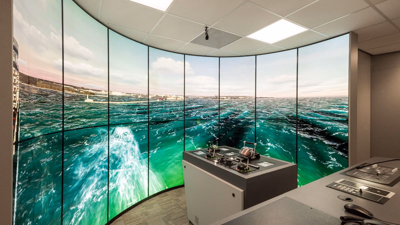 Bridge simulator room with multi-screen ship navigation setup