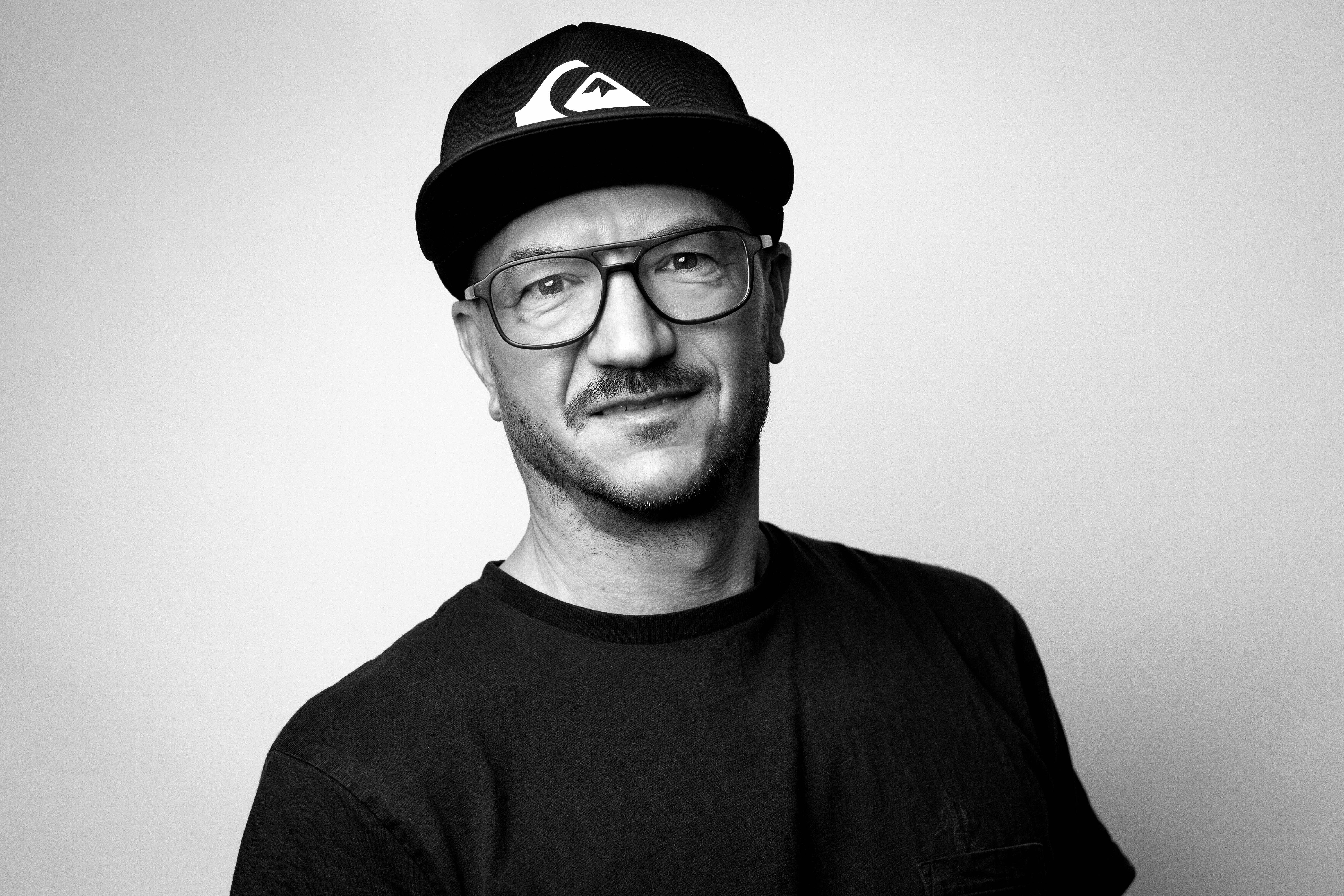 Black and white portrait of Nik Benner in cap and glasses