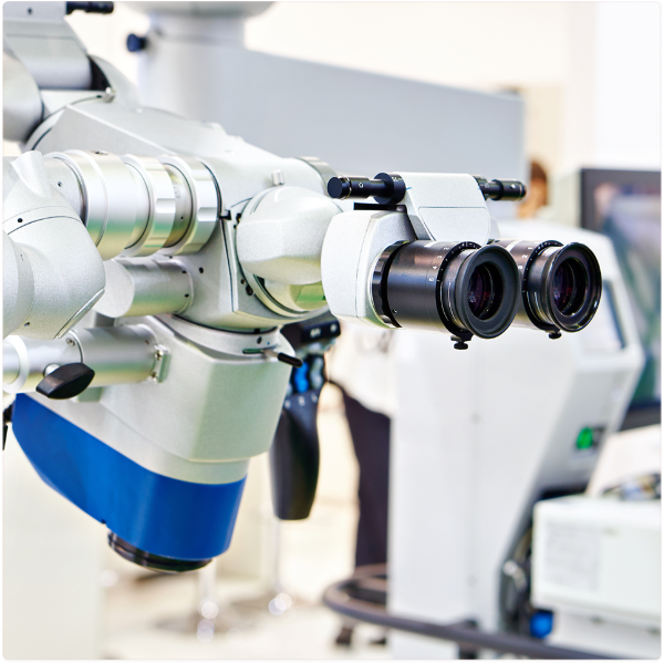 Close-up of a modern binocular microscope with dual eyepieces in a laboratory setting.