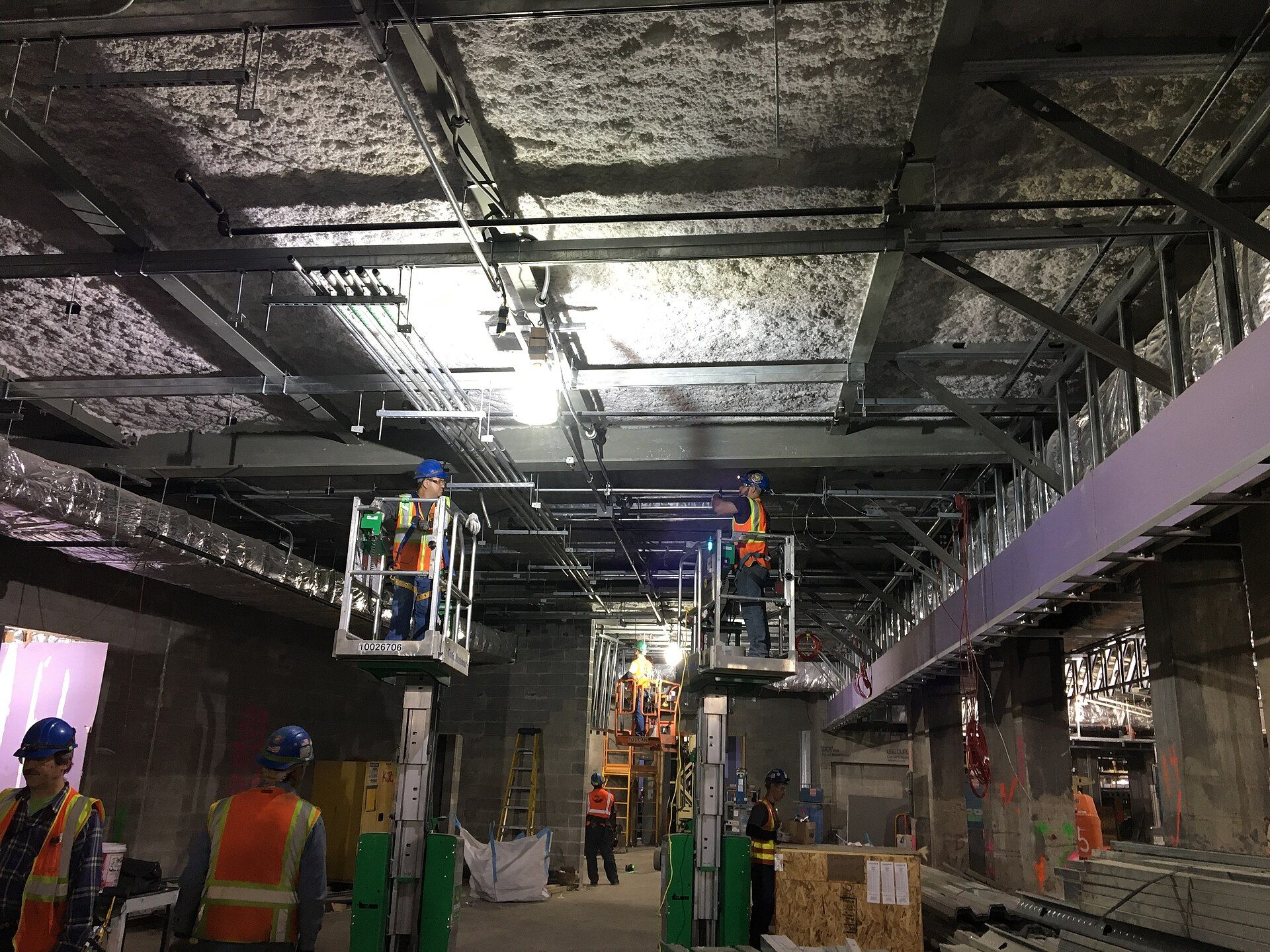 Electricians installing conduit on a commercial project