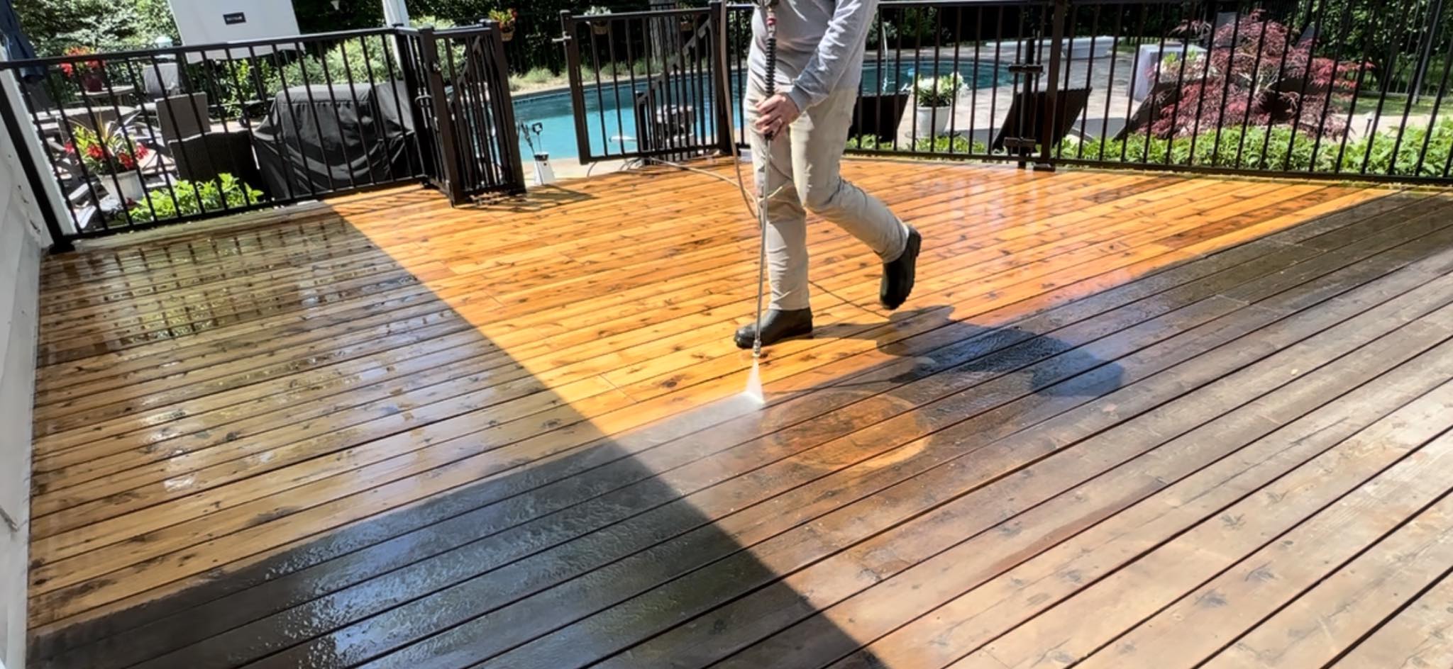 Power washing a wood deck during pre-stain surface preparation
