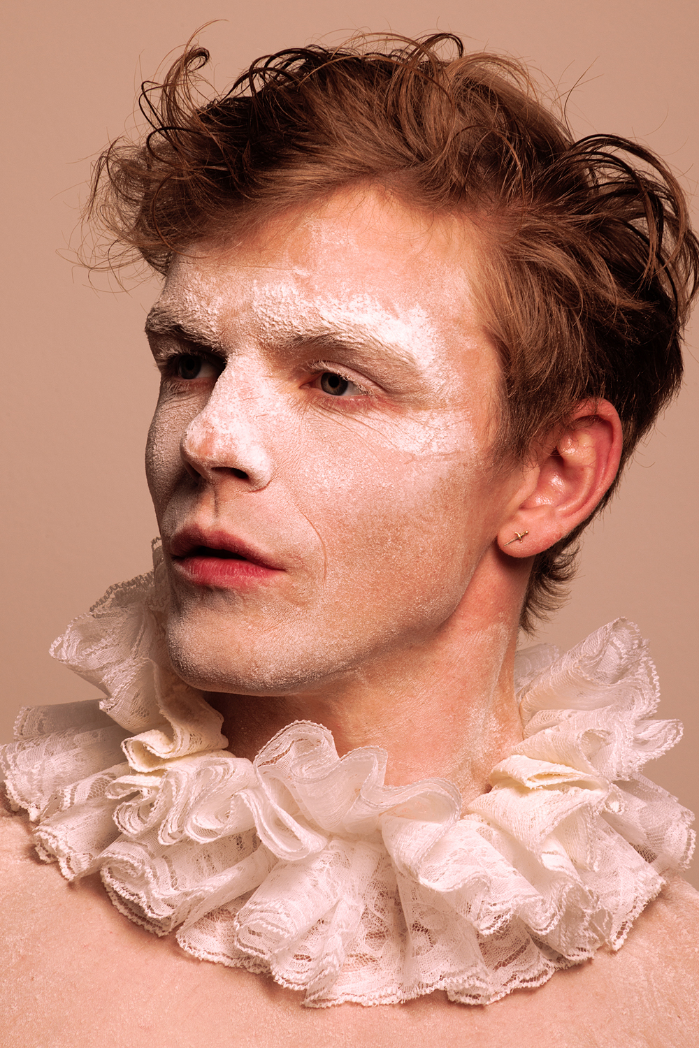 a man with white powder on his face