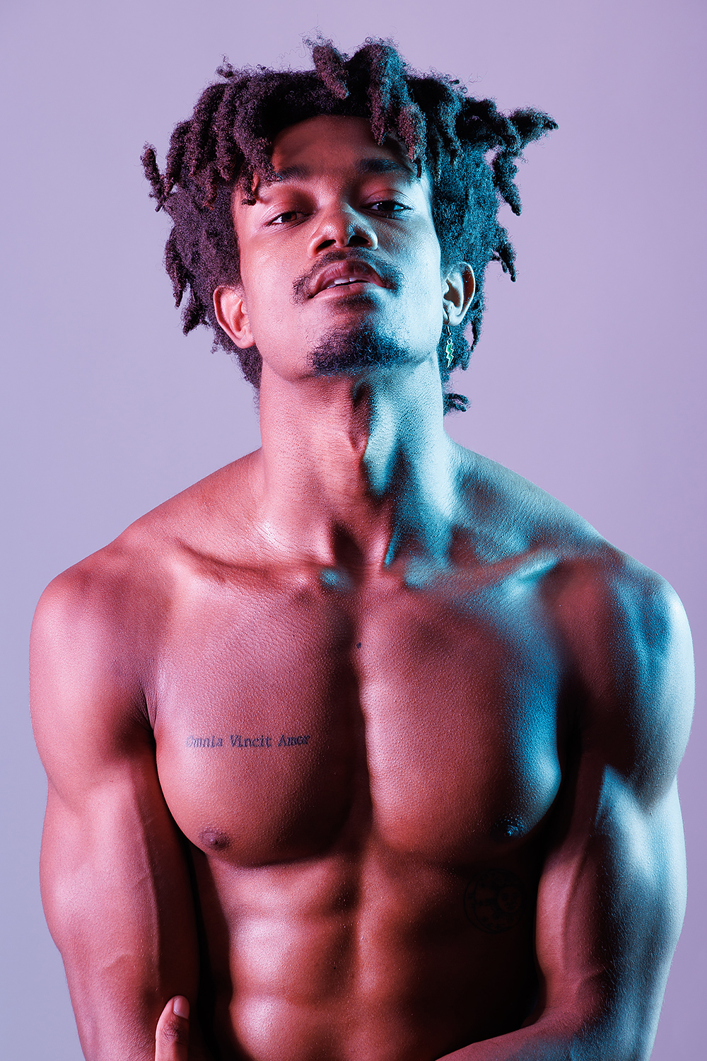 a man with dreadlocks shirtless