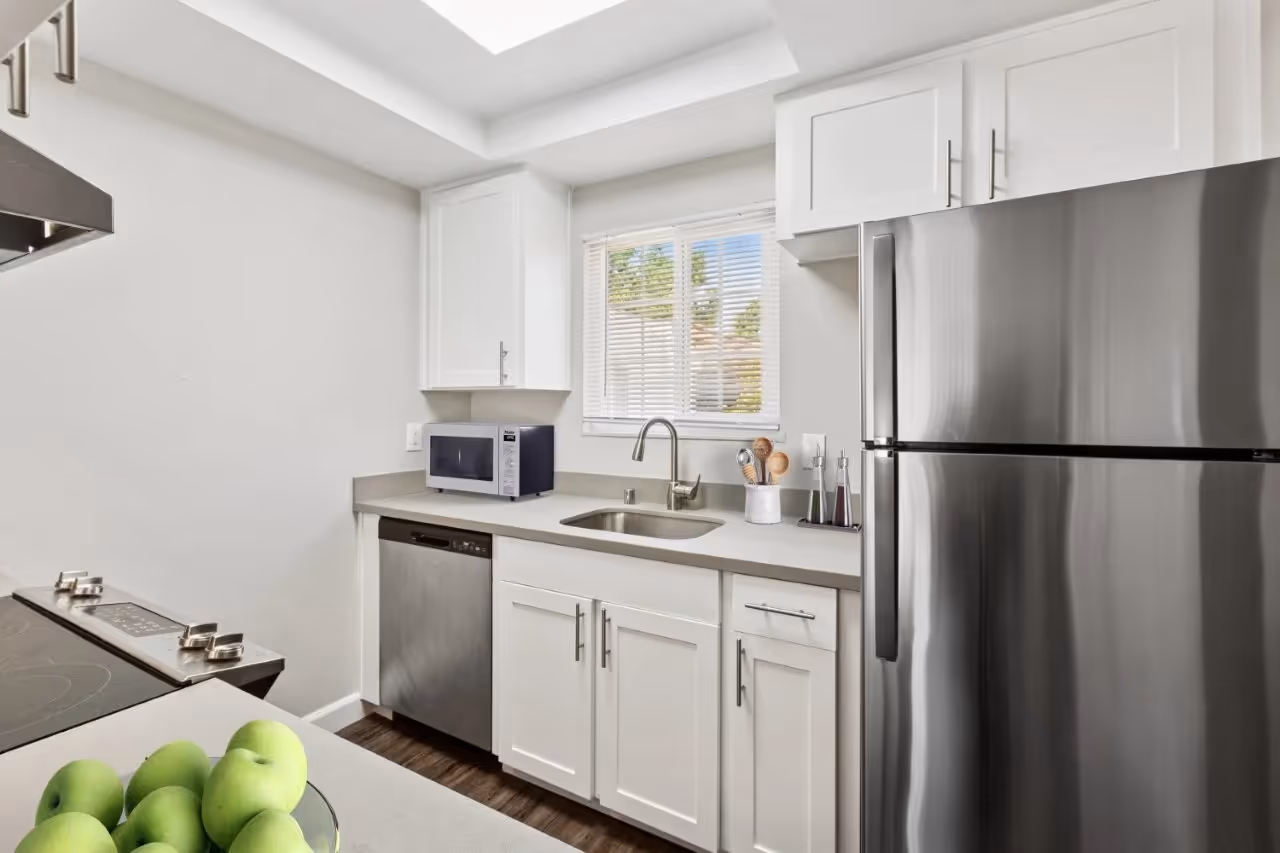 Kitchen with white cabinets and stainless steel appliances