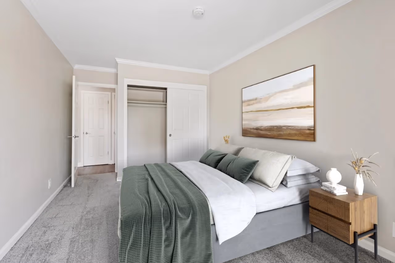 Virtually staged bedroom with bd, bedside tables, and wall art