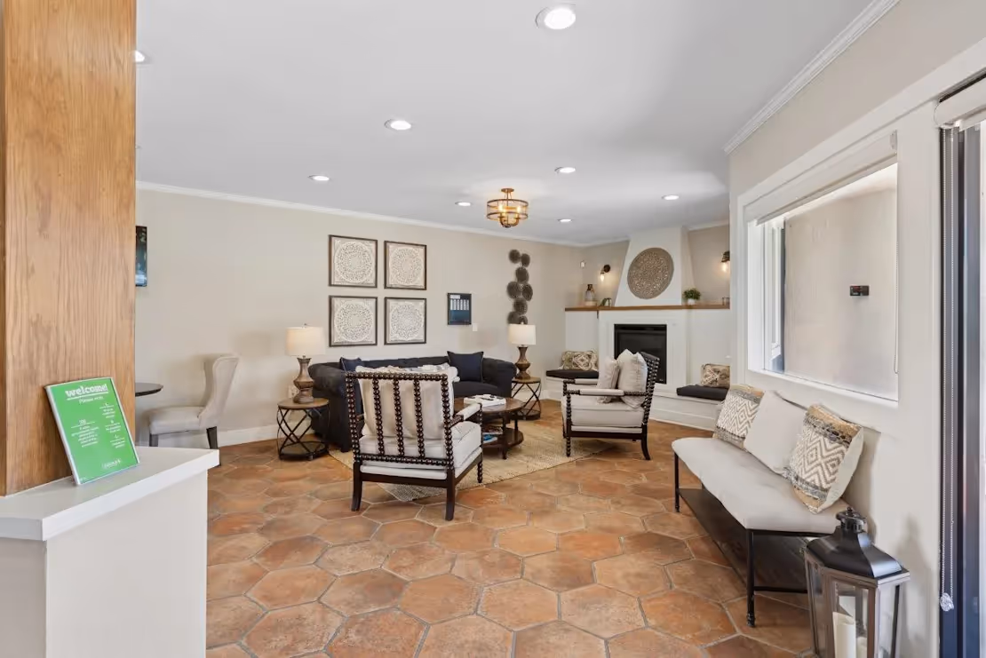 Clubhouse lounge with seating area with sofa and fireplace