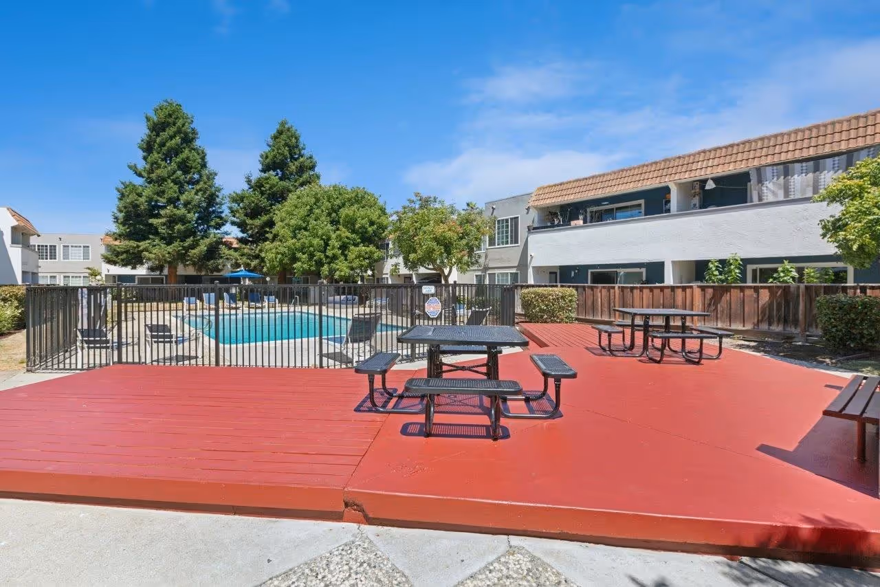 Picnic area with tables near swimming pool