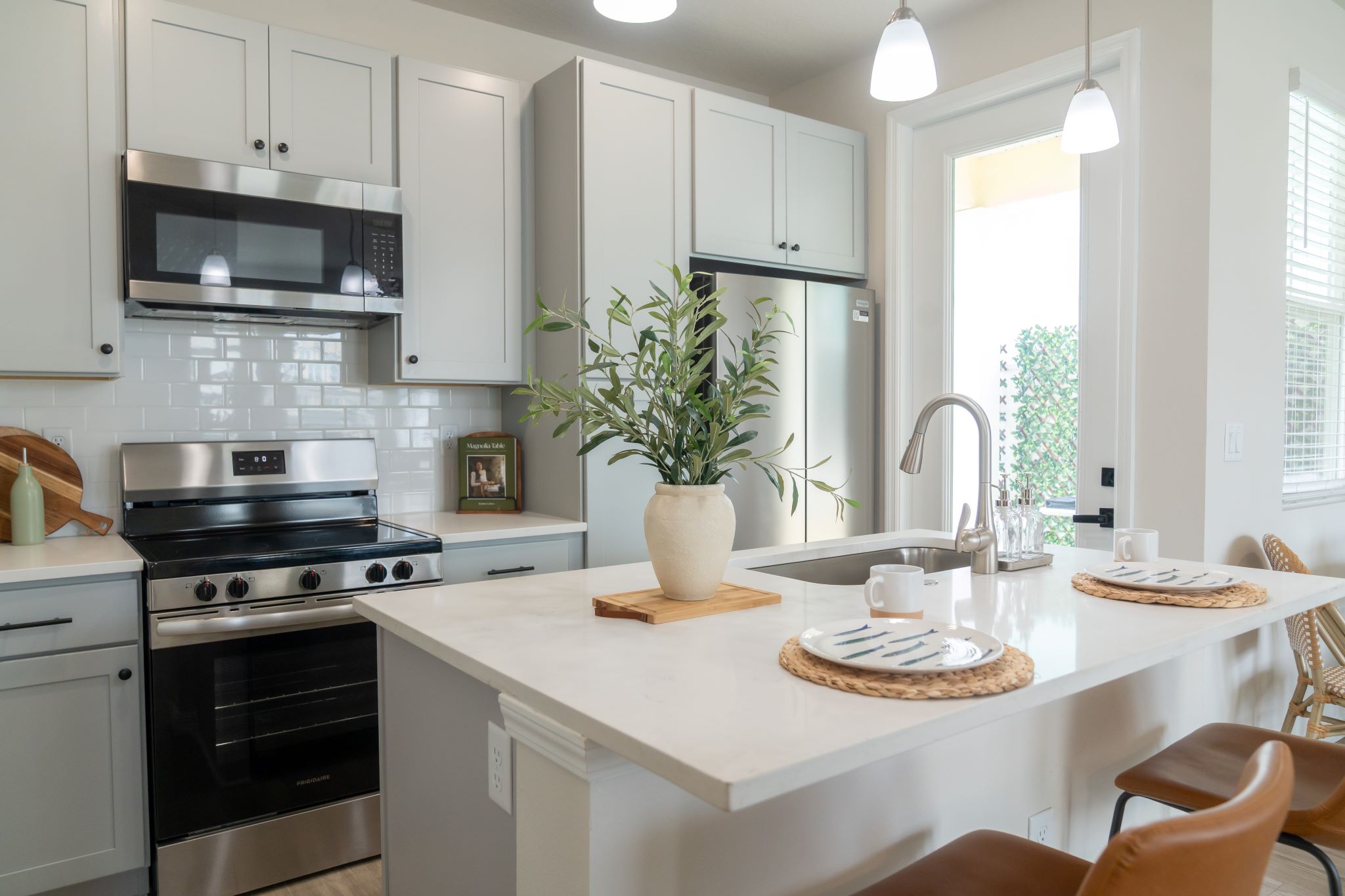 3D Rendering of dining area and kitchen with island and stainless steel appliances
