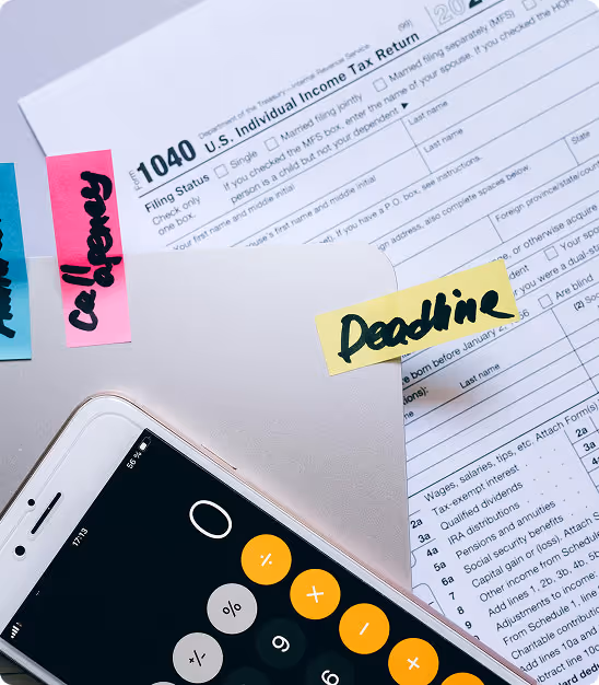 Calculator on smartphone over U.S. 1040 individual tax return with colorful sticky notes.