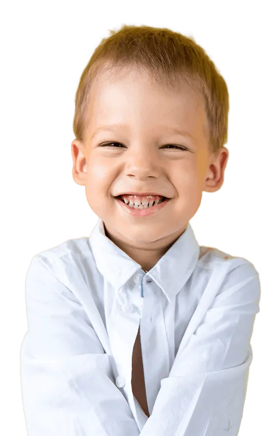 Smiling young boy wearing a white button-up shirt with arms crossed.