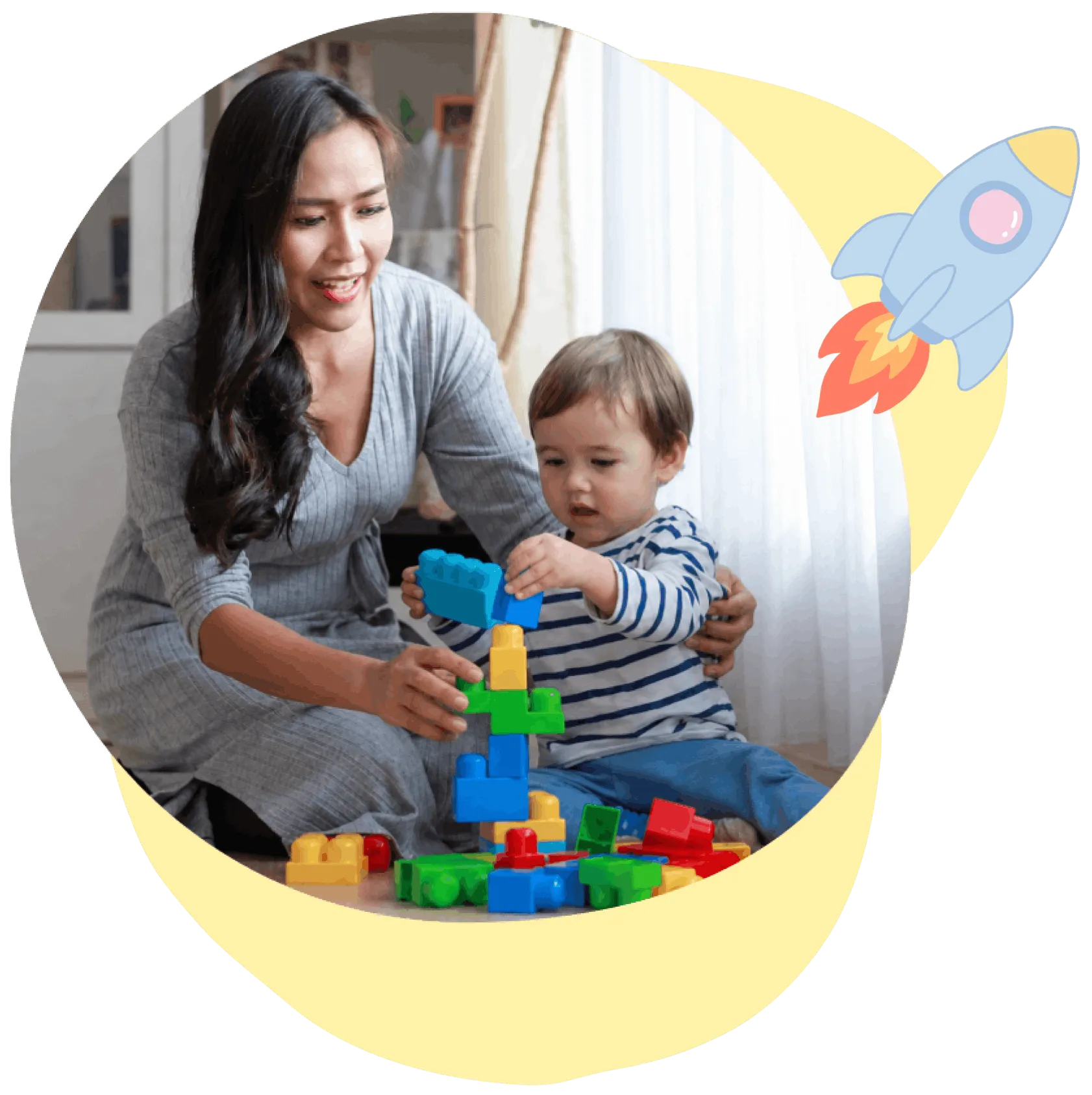 Woman and toddler play together, stacking colorful plastic building blocks on the floor.