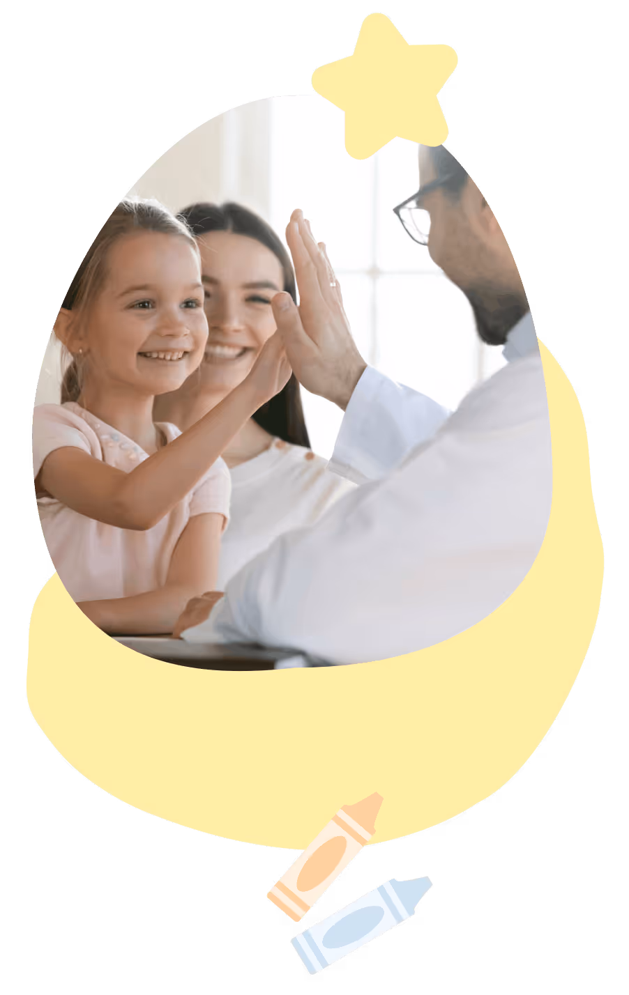 Smiling girl and woman giving a high five to a man wearing glasses in a bright room.