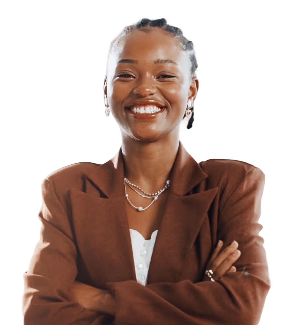 Smiling woman in a brown blazer with folded arms wearing layered necklaces and earrings.