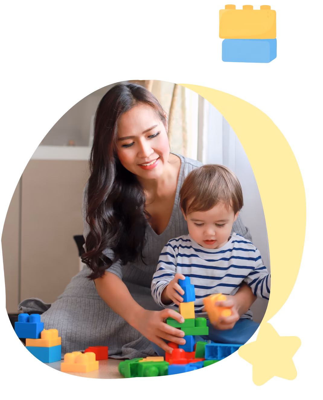 Woman and toddler playing with colorful building blocks together indoors.