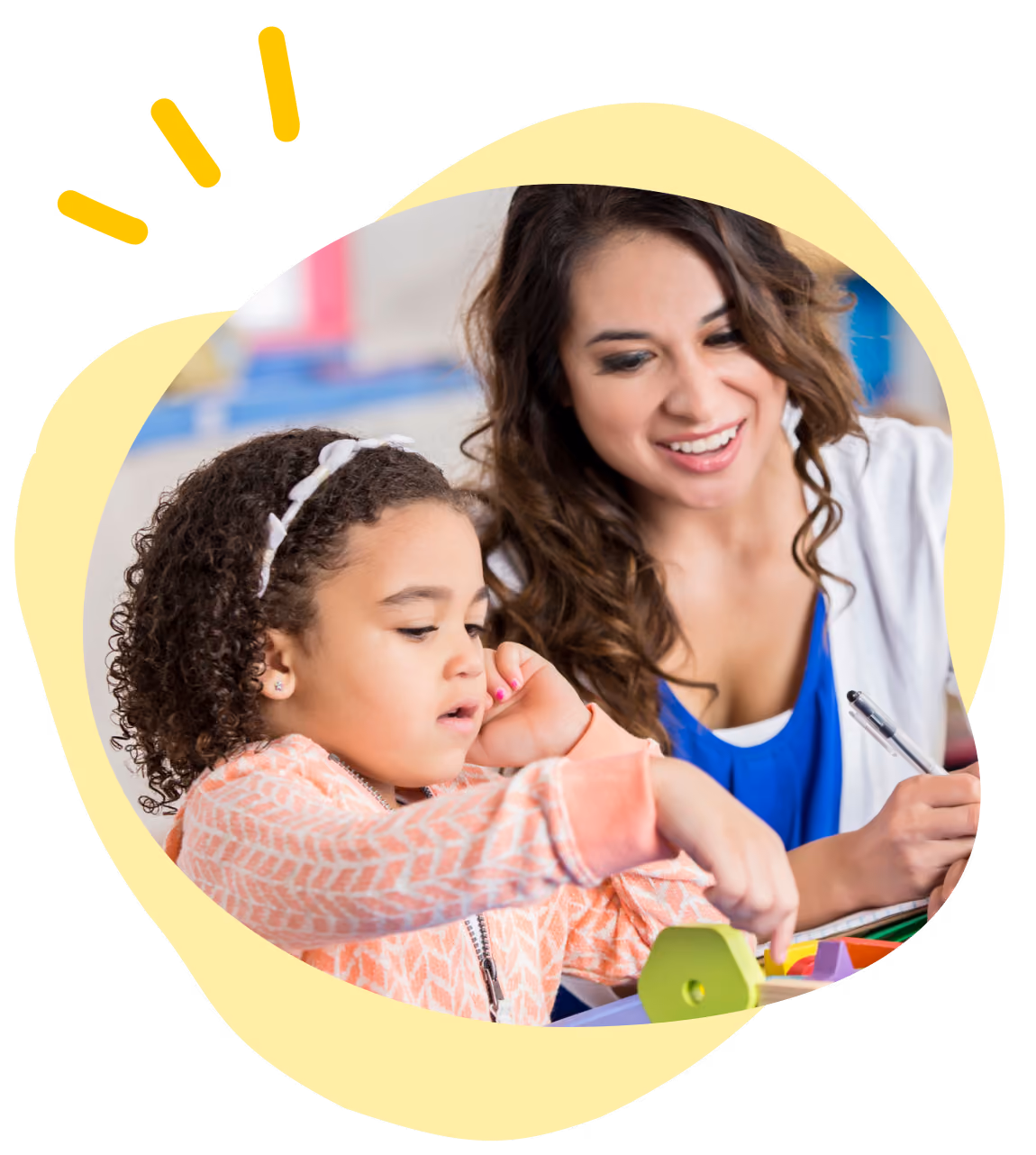 Woman smiling and watching young girl play with colorful wooden shapes in learning activity.
