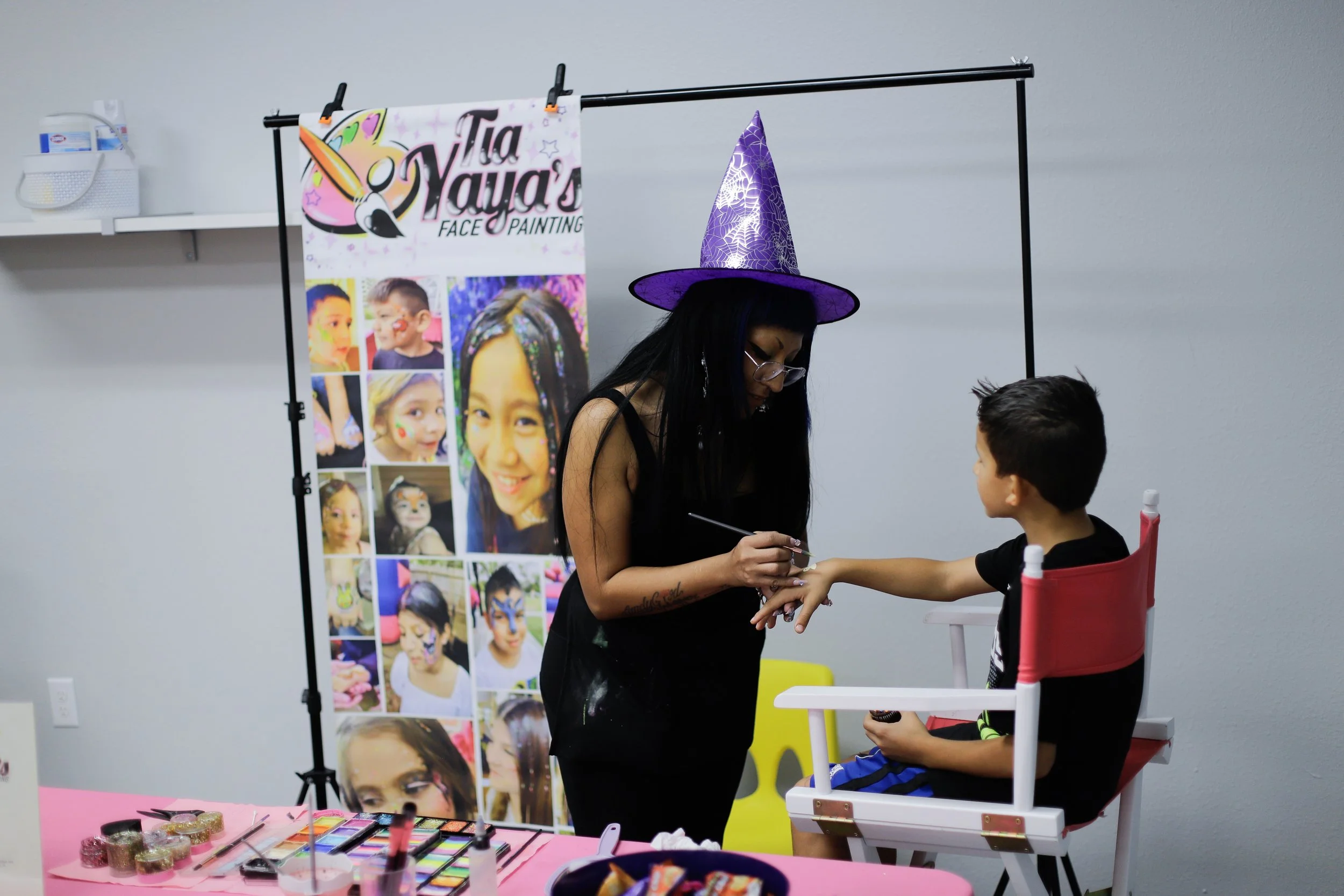 Child getting fall face painting at grand opening at Behavior Frontiers autism therapy center