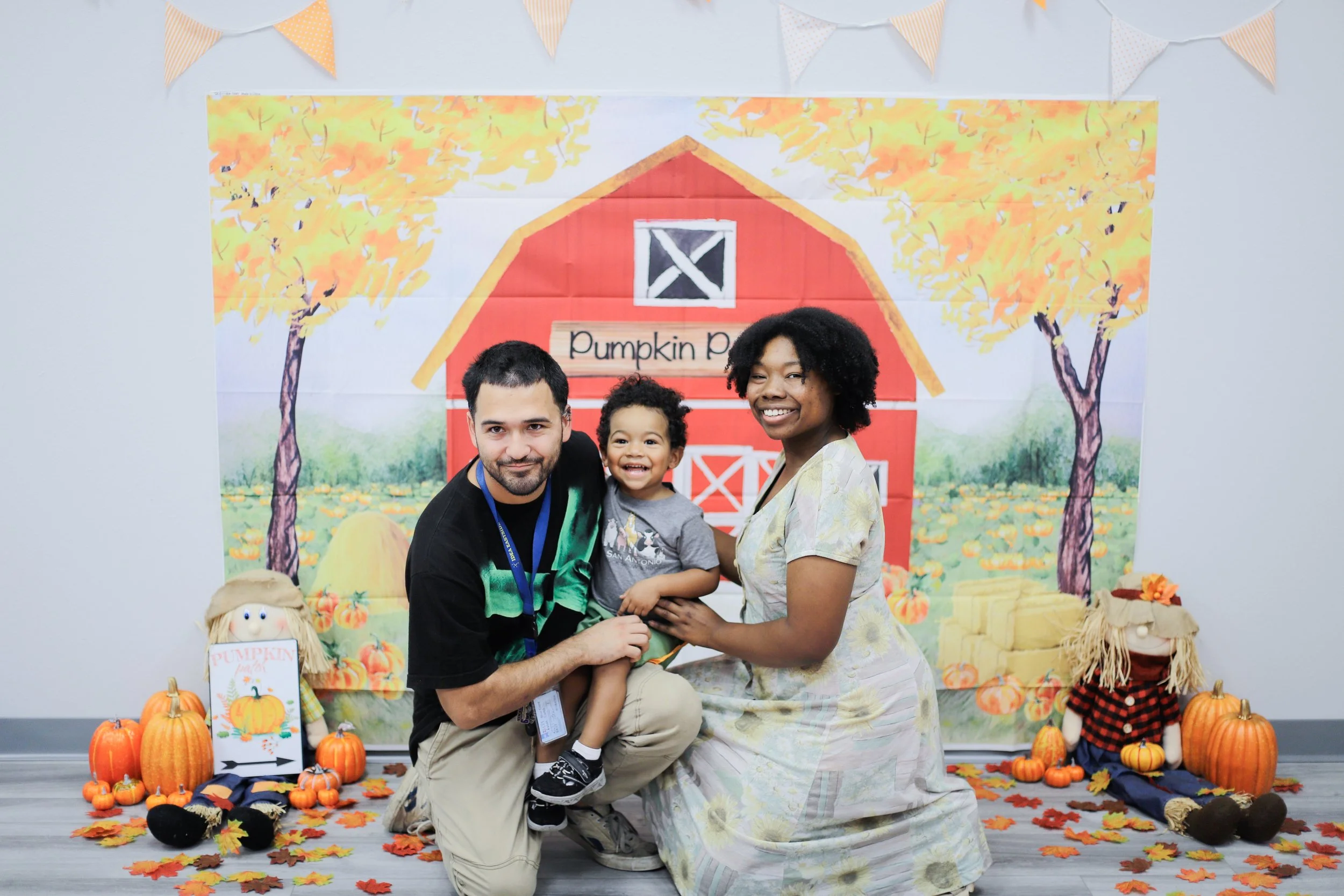 Indoor pumpkin patch setup with plush pumpkins and photo backdrop at San Antonio ABA therapy center
