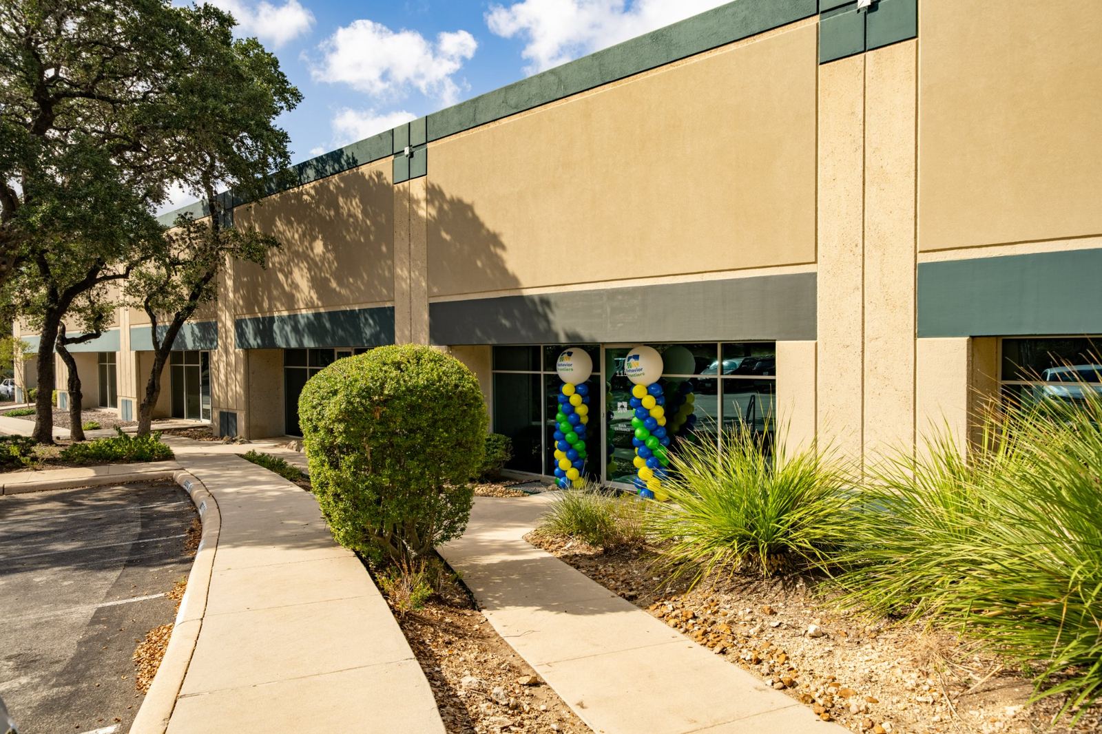 Exterior of the Behavior Frontiers ABA center with balloon columns at the entrance