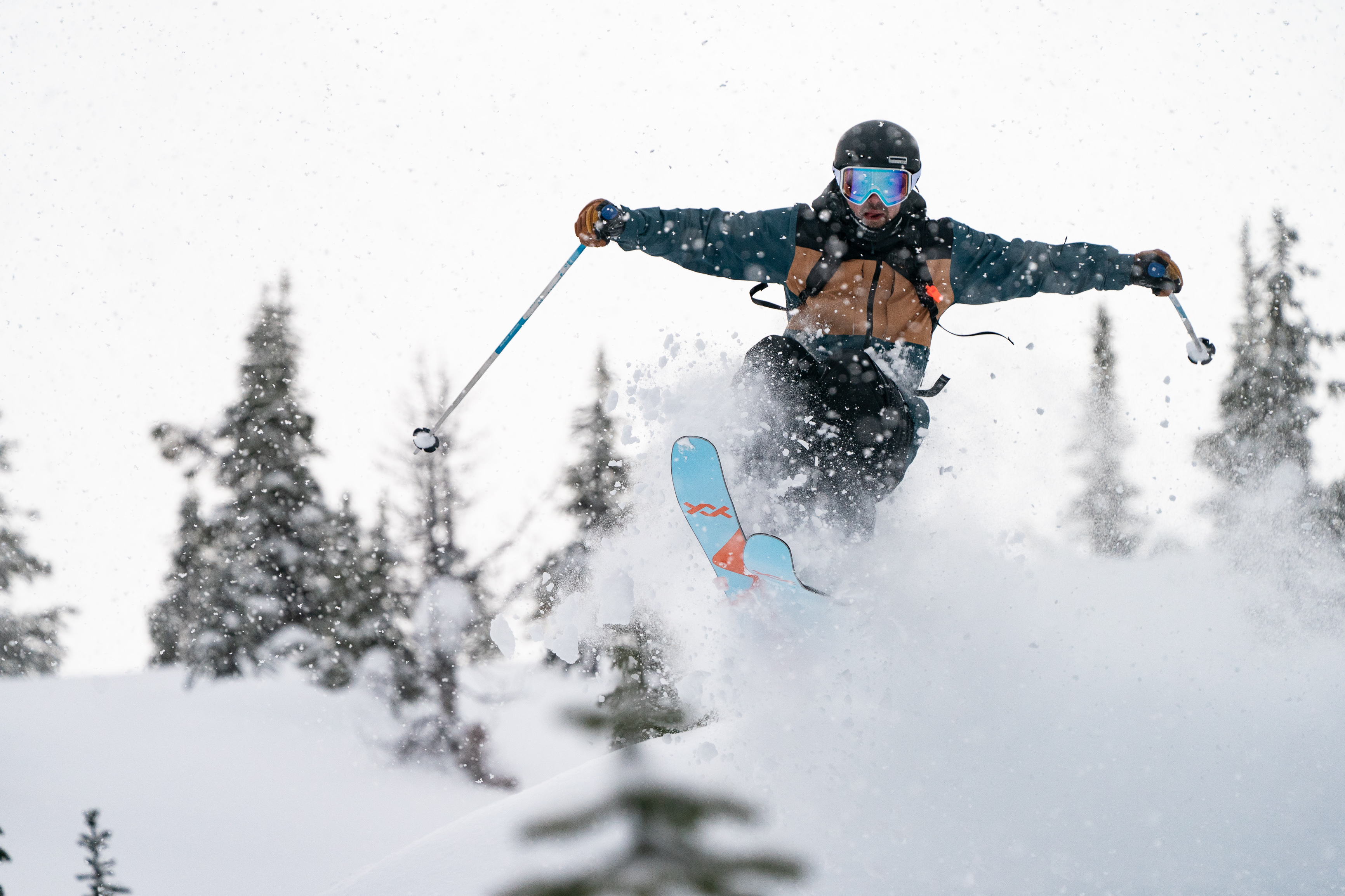 Skier skiing and jumping out of powder snow
