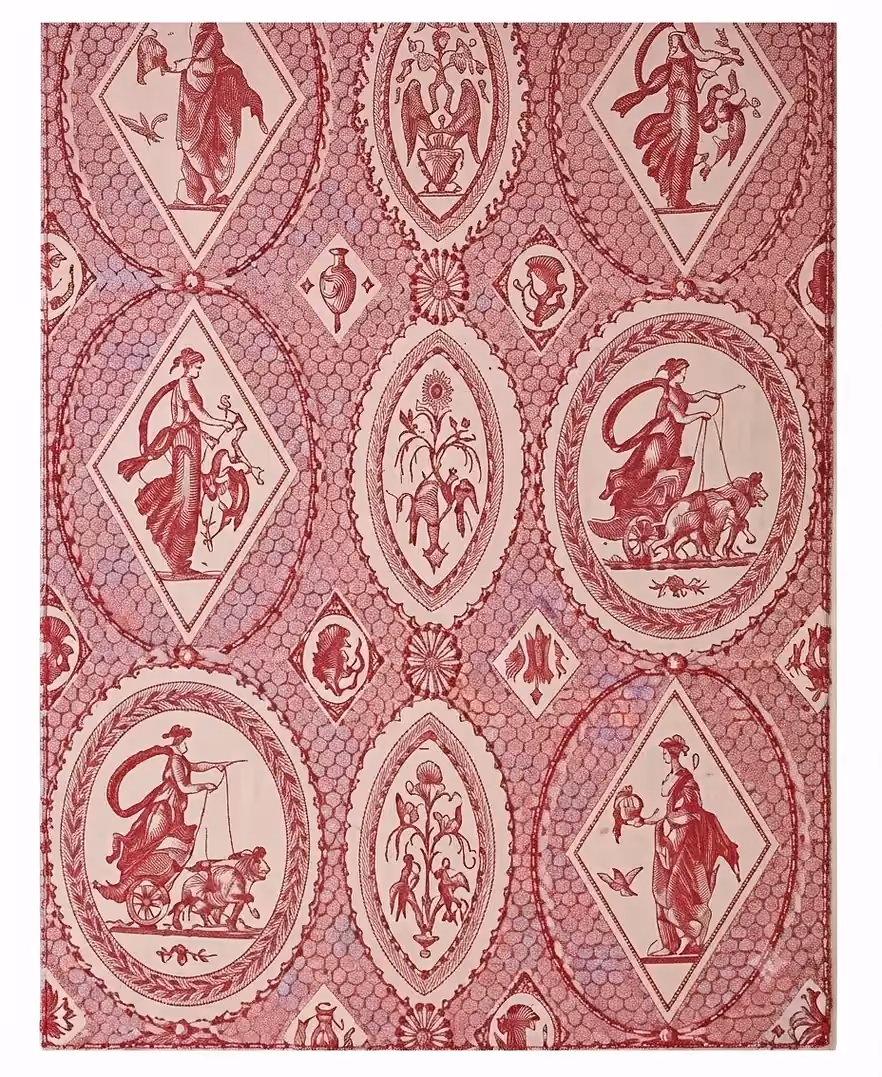 Red patterned fabric adorned with geometric medallions containing mythological figures.