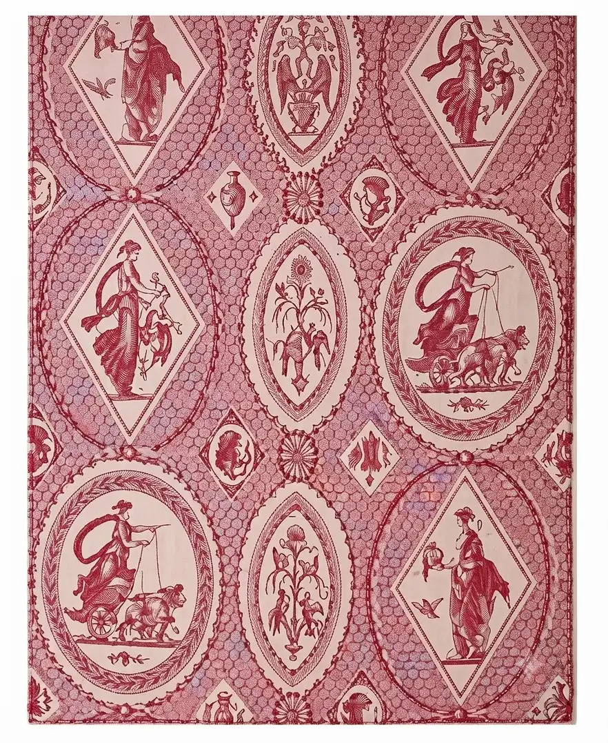 Red patterned fabric adorned with geometric medallions containing mythological figures.