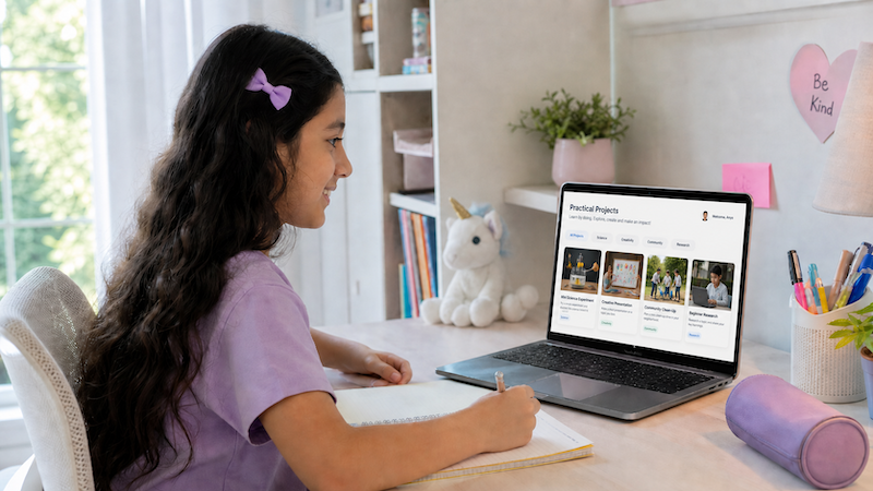 Young girl with long dark hair and purple bow studying at a desk with notebook and laptop showing Practical Projects webpage.